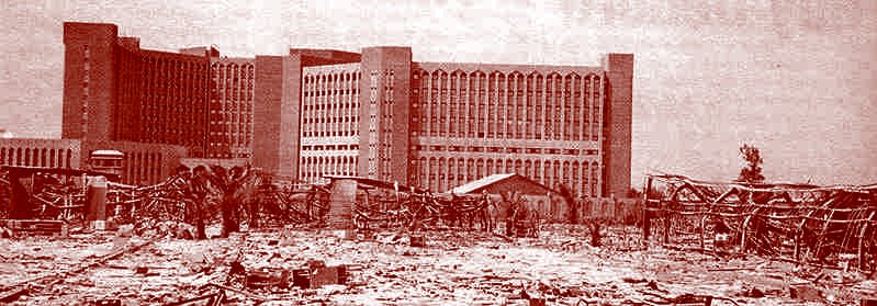 The Iraqi Oil Ministry, almost never shown in the  American press, is seen here post-invasion '03, untouched, in the background. The ruins of the Ministry of Water are in the foreground. Image courtesy Christian Parenti, as printed in the Brooklyn Rail, Oct '03 edition.
